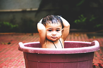 Cute Baby Girl Bathing in Pink Tub