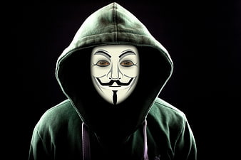 Anonymous Hacker in Green Hoodie and Guy Fawkes Mask
