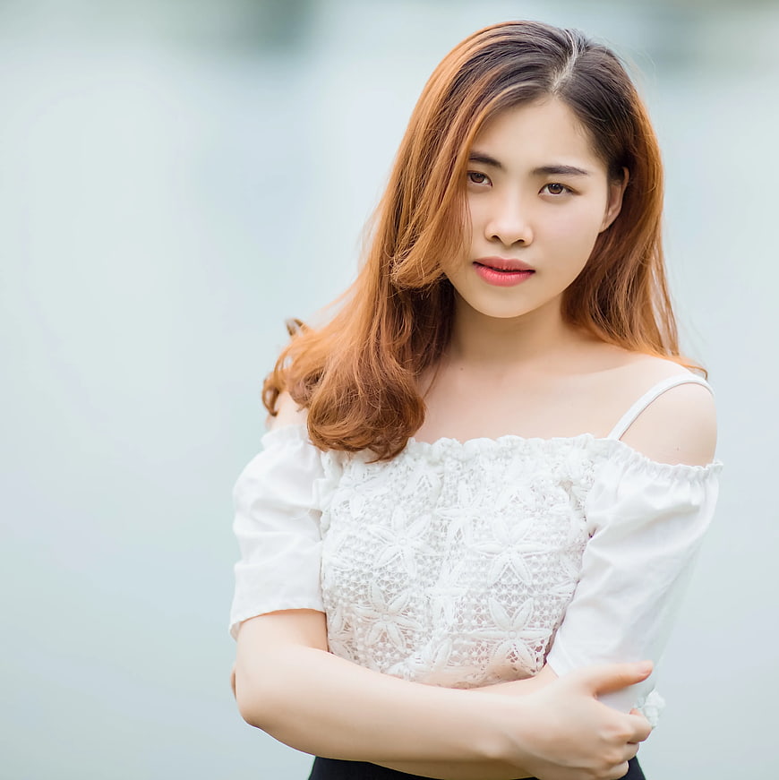 Young Asian Woman in White Off-Shoulder Top
