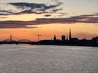 Riga Skyline at Sunset with Vanšu Bridge and Church Spires