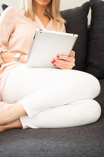 Woman Relaxing on Sofa with Tablet