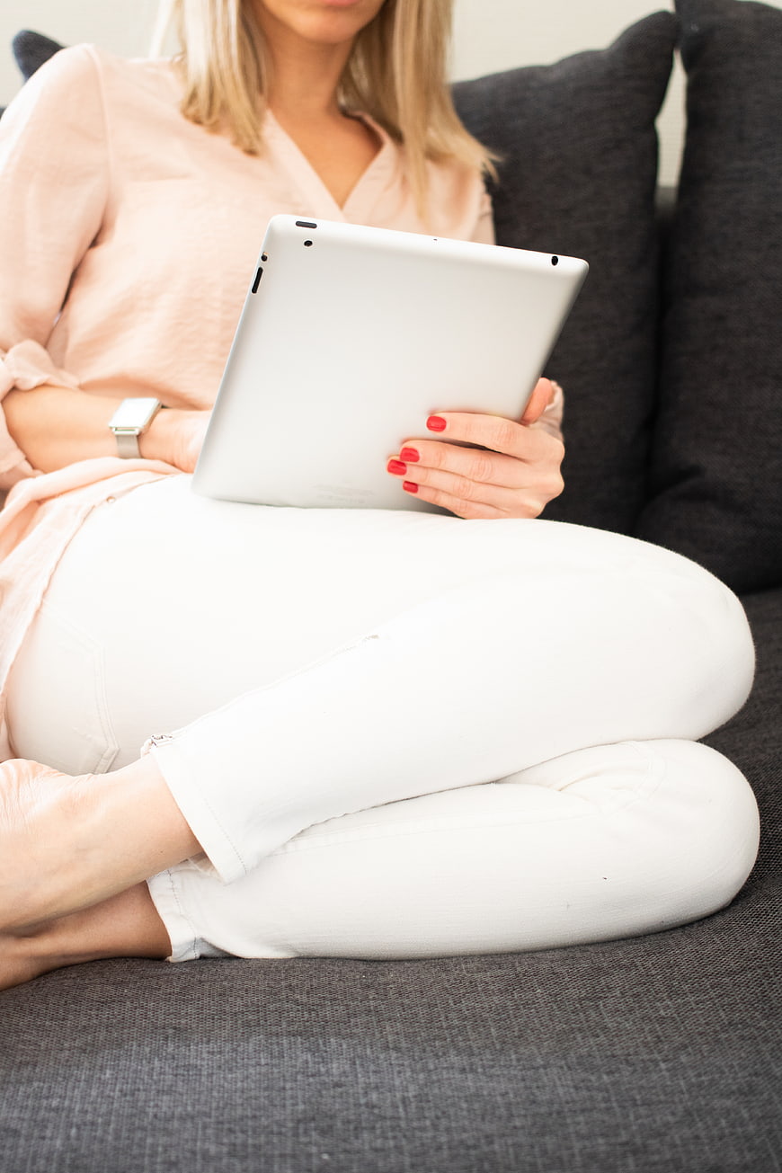 Woman Relaxing on Sofa with Tablet