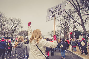 Woman holding protest sign at women's march rally