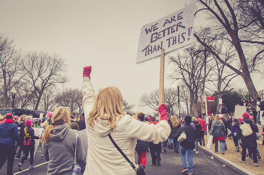 Woman holding protest sign at women's march rally