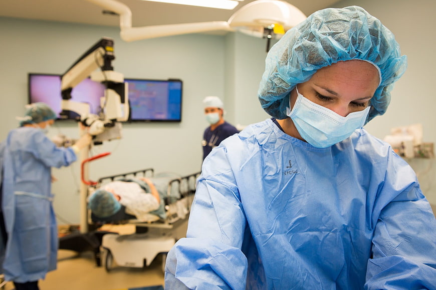 Female Surgeon in Blue Scrubs During Eye Surgery Operation