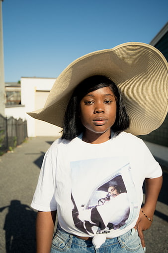 Young Black Woman in Oversized Straw Hat and Graphic Tee