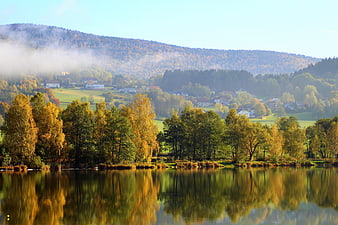 Serene Autumn Lake Landscape with Misty Mountains and Golden Trees