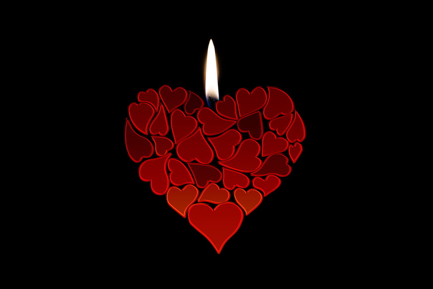 Red Heart Candle with Flame on Black Background