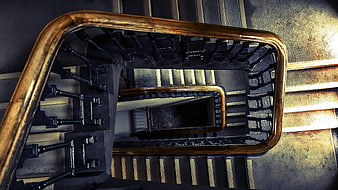 Top-down view of spiral staircase with wooden railing