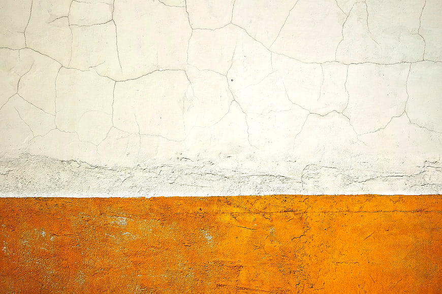 Textured Cracked Wall with White and Orange Paint Sections