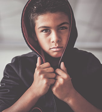 Portrait of Teenage Boy in Black Hoodie Looking at Camera