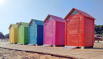 Colorful Beach Huts On Wooden Boardwalk