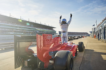 Formula 1 driver celebrating victory on the race track