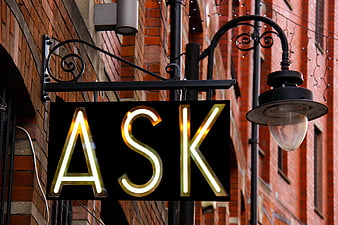 Neon Ask Sign on Brick Wall
