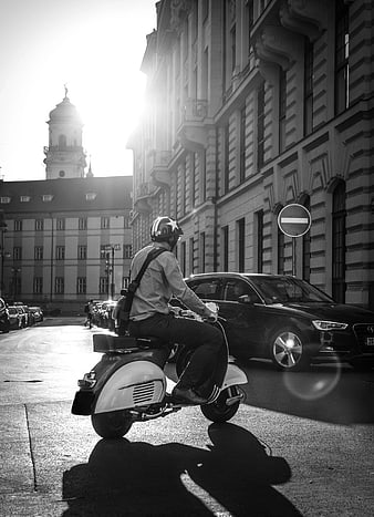 Man Riding Vintage Scooter in European City Street