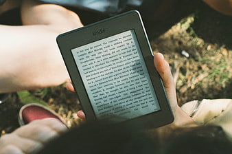 Person Reading Kindle E-Book Outdoors in Nature