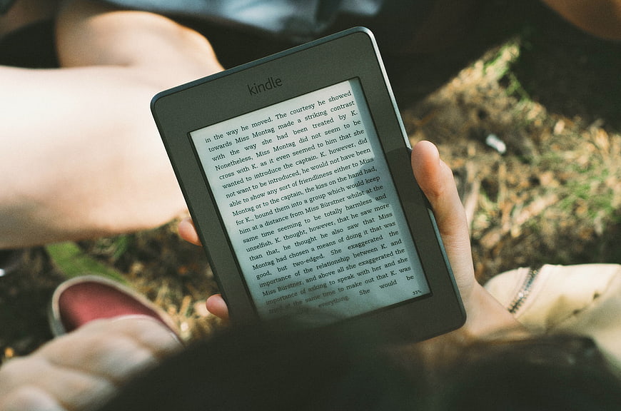 Person Reading Kindle E-Book Outdoors in Nature