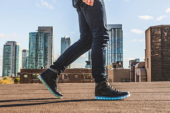 Person Wearing LED Light Up Sneakers on City Rooftop