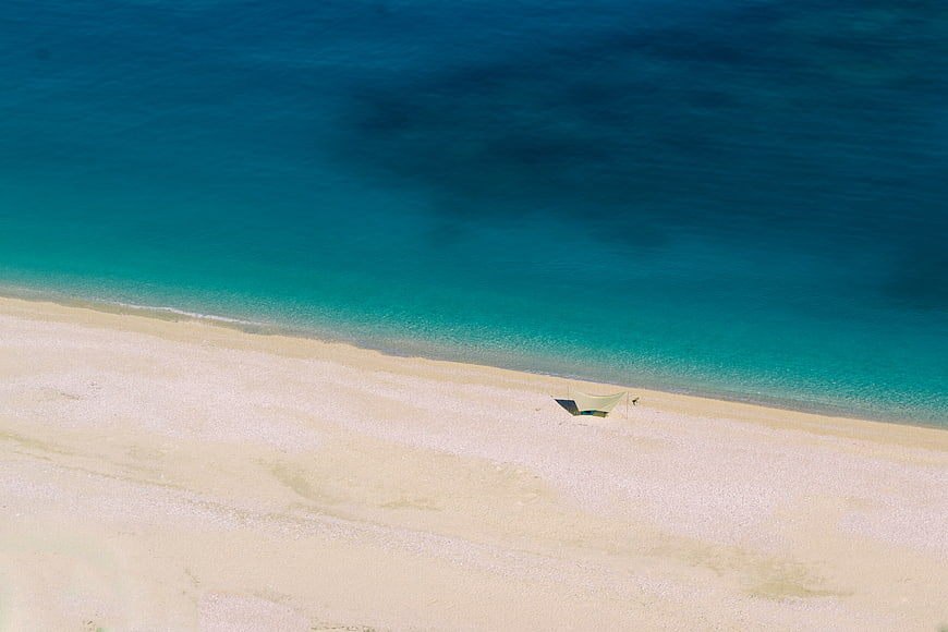 Aerial View of Turquoise Sea and White Sandy Beach