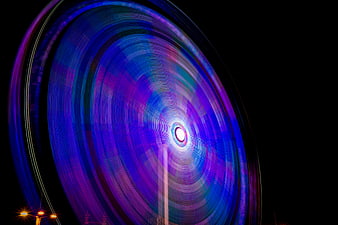 Abstract long exposure ferris wheel light trails at night