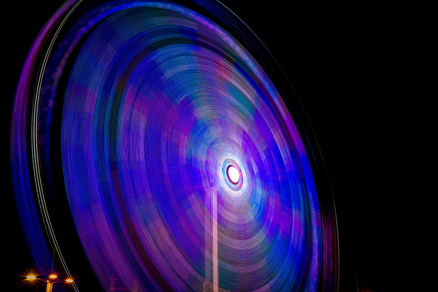 Abstract long exposure ferris wheel light trails at night