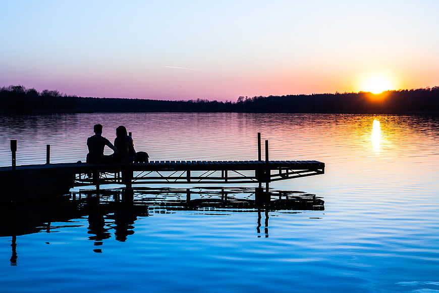Couple Silhouette on Dock at Sunset Lake
