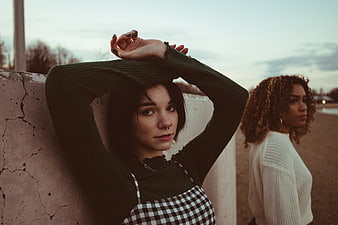 Two Young Women Posing Outdoors at Dusk