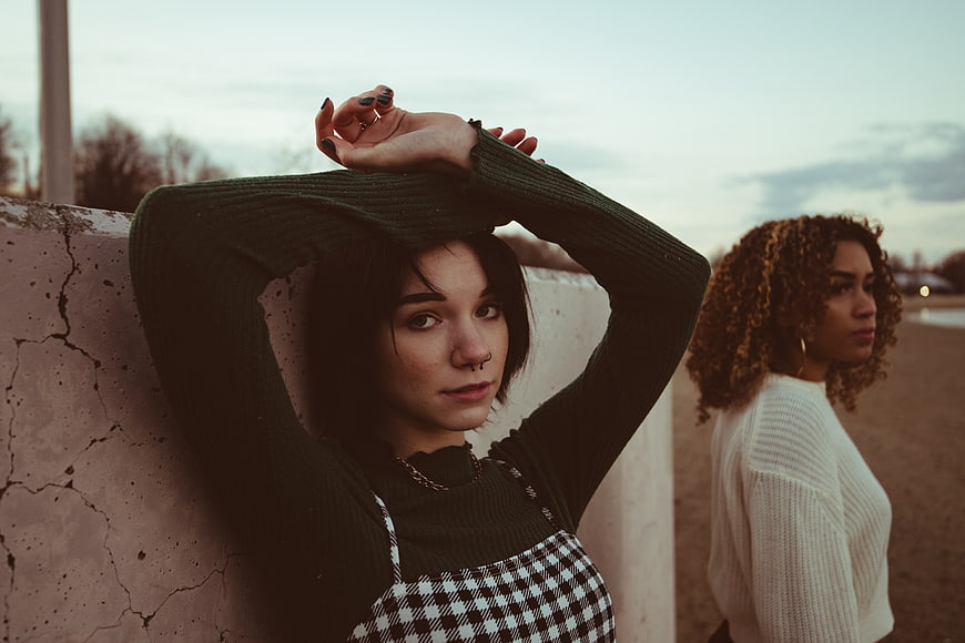 Two Young Women Posing Outdoors at Dusk