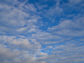 Blue Sky with Fluffy White Clouds Background