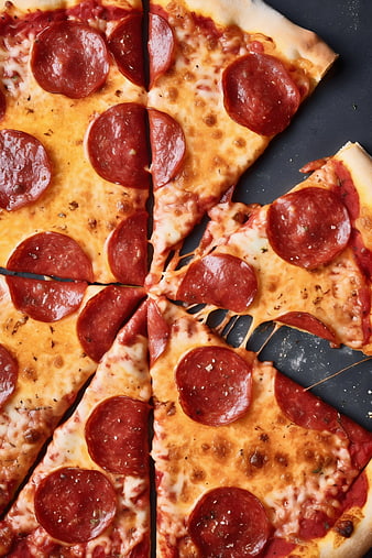 Top View of Sliced Pepperoni Pizza on Dark Background