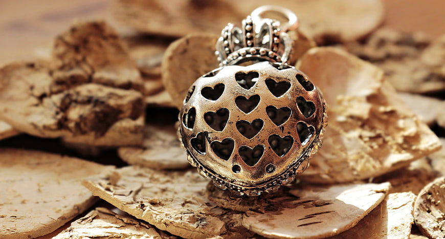 Vintage silver heart locket on birch bark texture