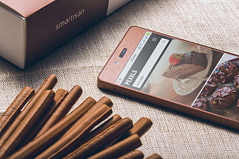 Smartisan smartphone displaying chocolate desserts on textured fabric