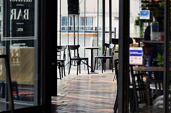 Empty cafe terrace viewed through glass doors