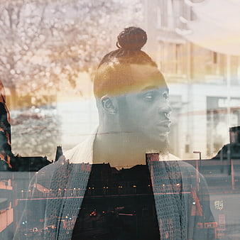 Double exposure portrait of man with cityscape overlay