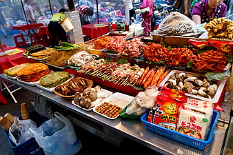 Vibrant Korean street food market stall with skewers and ingredients