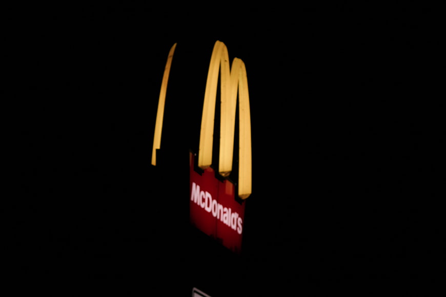 Illuminated McDonald's Golden Arches Sign at Night
