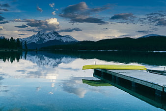 Yellow Canoe on Dock with Mountain Lake Reflection