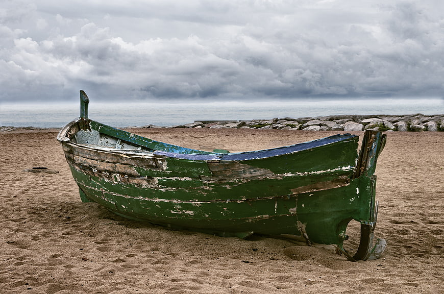 Weathered Green Wooden Boat on Sandy Beach