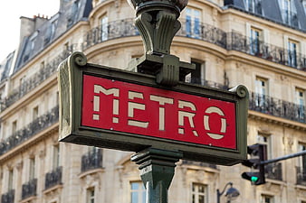 Classic Paris Metro Sign on Street Corner