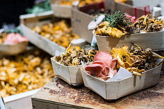 Fresh wild mushrooms in wooden crates at a farmers market