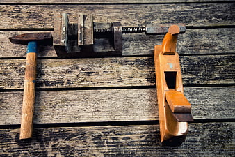 Vintage carpentry tools on rustic wooden background