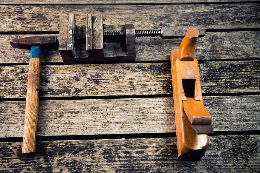 Vintage carpentry tools on rustic wooden background