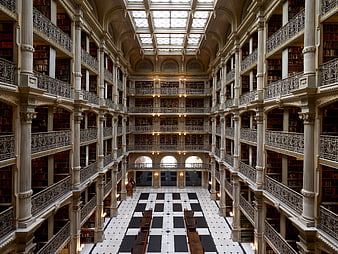 Grand historic library interior with skylight and bookshelves