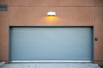 Modern gray garage door on terracotta building exterior