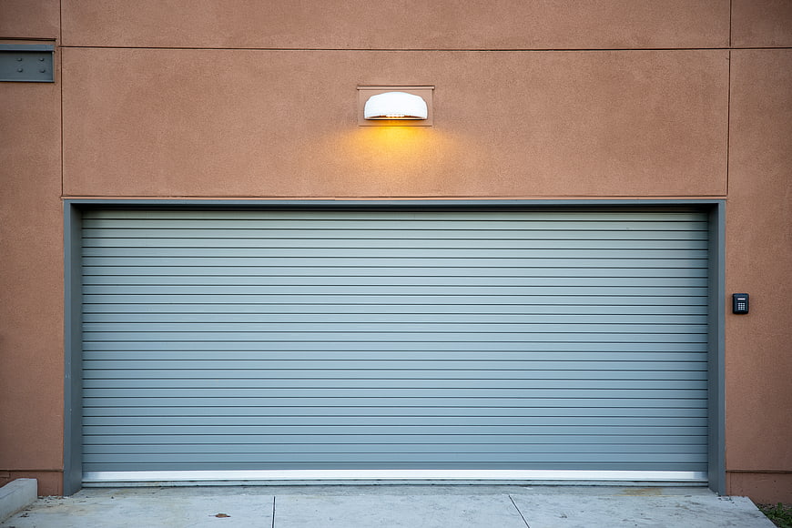 Modern gray garage door on terracotta building exterior