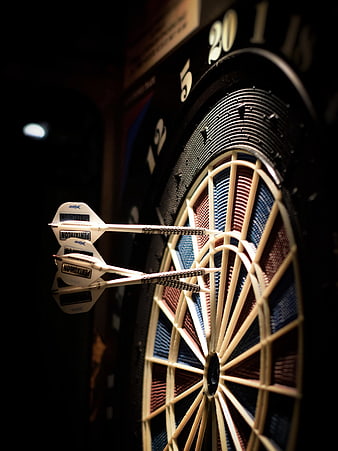 Close-up of darts stuck in a dartboard target