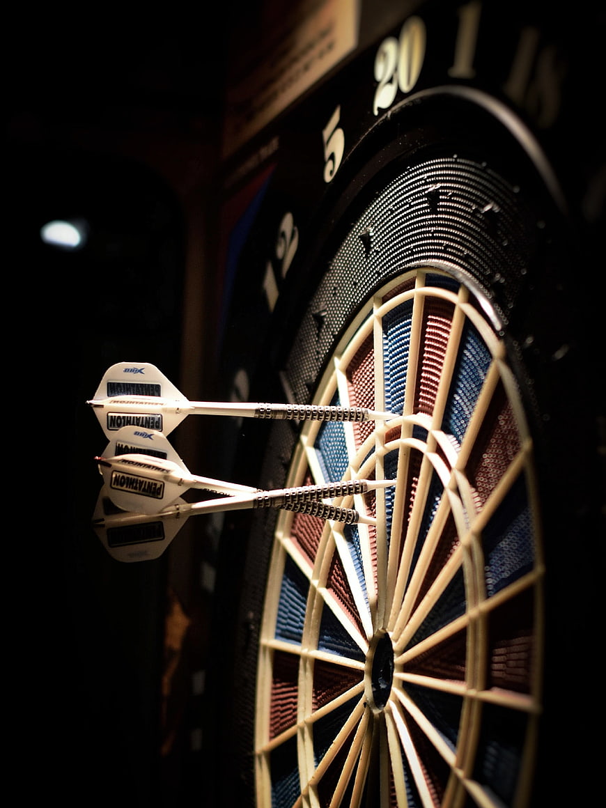 Close-up of darts stuck in a dartboard target