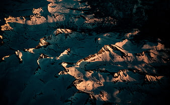 Aerial View of Snow-Capped Mountains at Golden Hour
