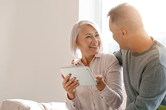 Happy Senior Couple Using Tablet at Home