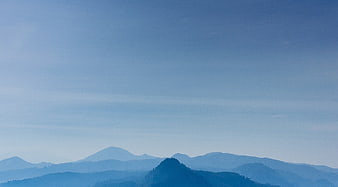 Serene Blue Mountain Landscape with Hazy Sky